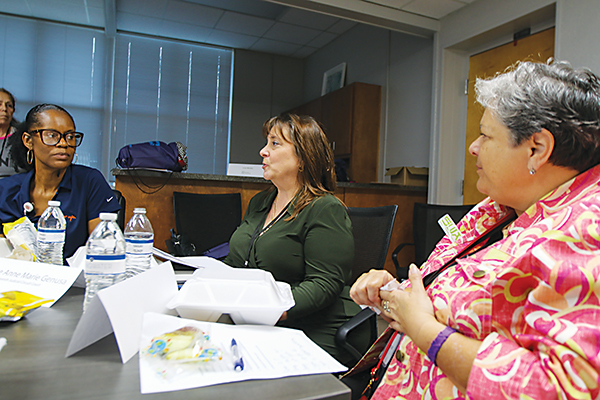 SARAH CAVACINI/Palatka Daily News – Judge Anne Marie Gennusa, center, speaks during Girls Can on Friday while Health Information Management Director Yvette Jones, left, and retired health care professional Mary Garica, right, listen.