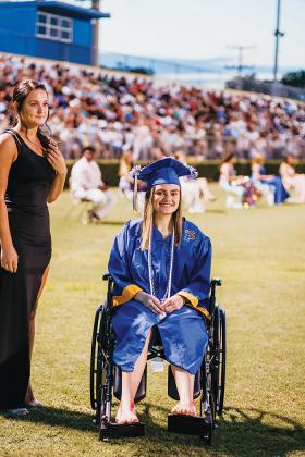 Lauren Hall, right, attends her graduation in Palatka days after being injured in a car crash.