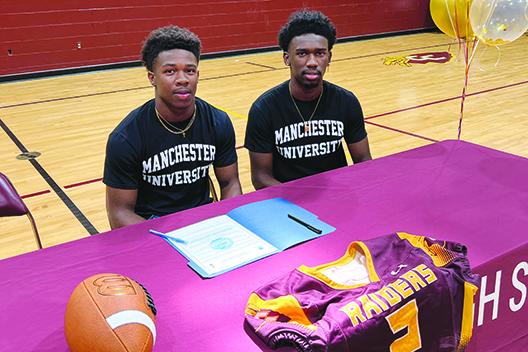 Brothers Naykeem (left) and Naykee Scott pose before signing letters of intent to play at Manchester University in Indiana last month. (Submitted / Sean Delaney)