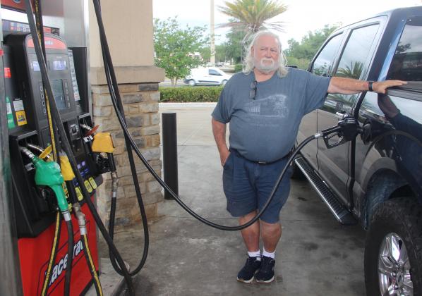 Resident Ken Yelvington pumps gas into his truck at the RaceTrac on State Road 19 Monday afternoon.