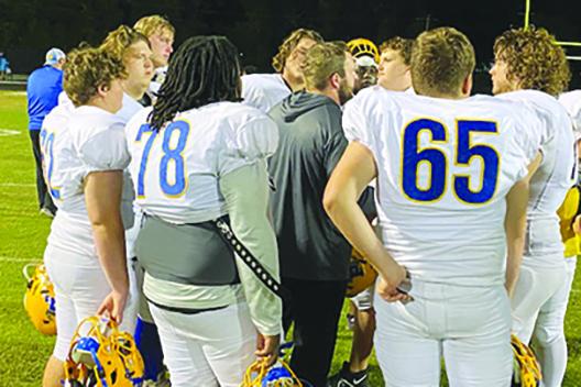 Palatka offensive line coach Paul Mast talks to his unit shortly after the Panthers outlasted Keystone Heights, 48-30, Friday. (COREY DAVIS / Palatka Daily News)