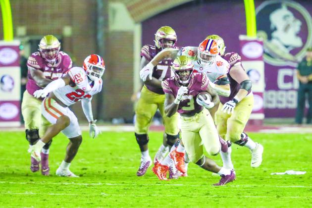 Florida State’s Trey Benson looks to escape Clemson defenders during Saturday night’s 34-28 loss at Doak Campbell Stadium. (GREG OYSTER / Special to the Daily News)
