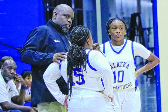 Palatka coach Craig Washington consults with Panther players Mikhia Peeples (15) and Destiny Williams. (RITA FULLERTON / Special to the Daily News)