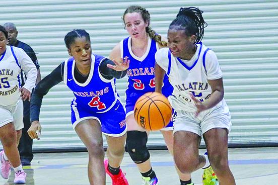 Palatka’s Ramiyah Oxendine (right) brings the ball up the court against the defense with Keystone Heights’ Yasmin Bryant Friday night. (RITA FULLERTON / Special to the Daily News)