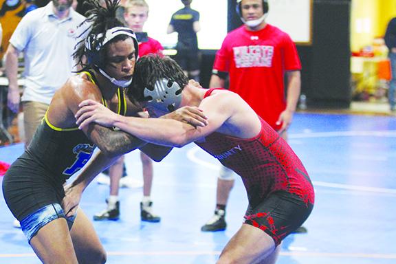 Palatka’s Ishmael Foster (left) tries to control Baker County’s Taz Kinghorn in the 132-pound title match at the District 4-1A wrestling championship at the C.L. Overturf 6th Grade Center gymnasium last week. (MARK BLUMENTHAL / Palatka Daily News)