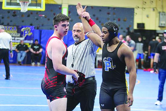 Palatka’s Dalvin Dallas (right) accepts the District 4-1A semifinal-round victory over Baker County’s Kristian Chancey at 190 pounds last week. (MARK BLUMENTHAL / Palatka Daily News)