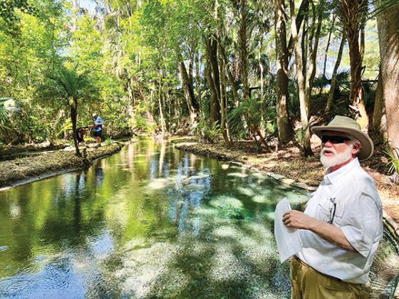 File photo – Sam Carr, president of the Bartram Trail Society of Florida, gives a history lesson in 2023 about Satsuma Spring while a group tours the site.
