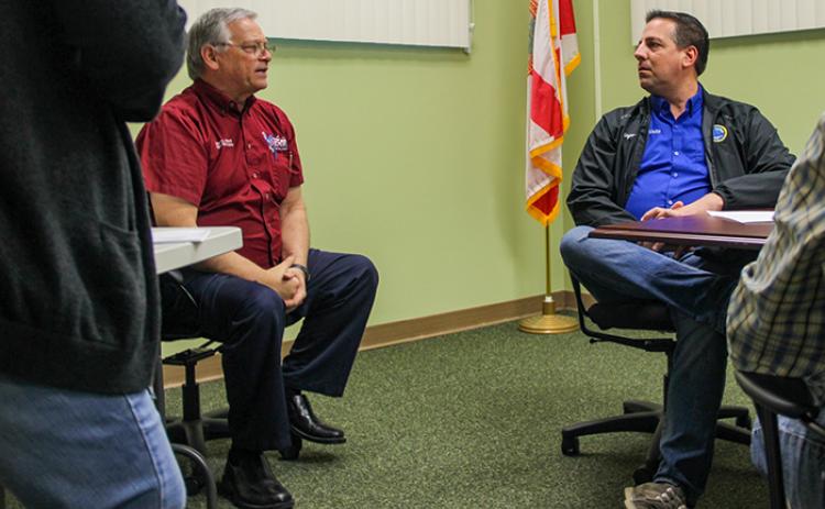 Supervisor of Elections Charles Overturf III, left, talks with Welaka Mayor Jamie Watts during a Canvassing Board meeting Friday at the elections headquarters in Palatka.