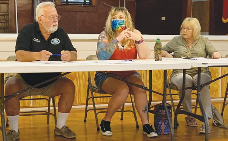 From left, Pomona Park Mayor Joe Svingala and council members CarrieAnn Evans and Lynda Linkswiler listen during a Saturday special meeting at the town’s community center as residents suggest projects the town could undertake using a $460,000 grant from the American Rescue Plan Act.