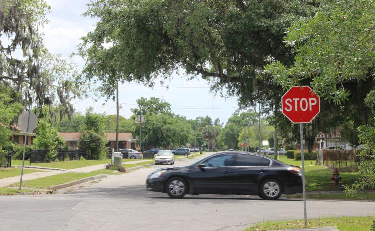 A car Wednesday afternoon crosses in front of a portion of North 18th Street that the City of Palatka is considering repaving.