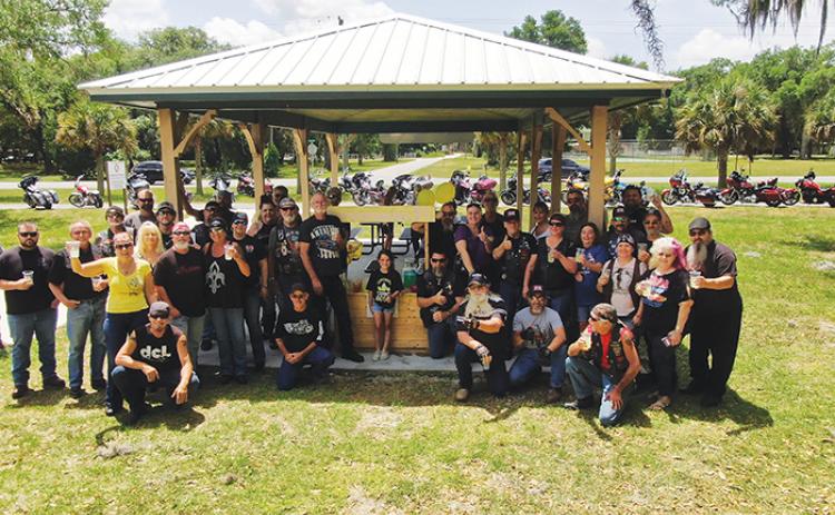Brylee Guessford, 7, center, stands among a group of motorcyclists who visited her lemonade stand Sunday to help raise money for her classmate, Kaleb Sheneman, who was hit by a car last week.