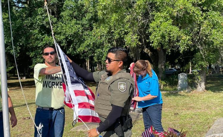 Putnam County Sheriff’s Office officials worked alongside inmate workers and Keep Putnam Beautiful spent Friday cleaning and replacing the American flags at St. Joseph’s Cemetery in Palatka. 