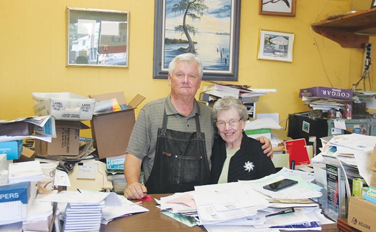 Sam Deputy and his mother Jean Deputy stand side by side in Graphics II print shop Wednesday afternoon. Graphics II is set to be closing soon to become a consignment shop.