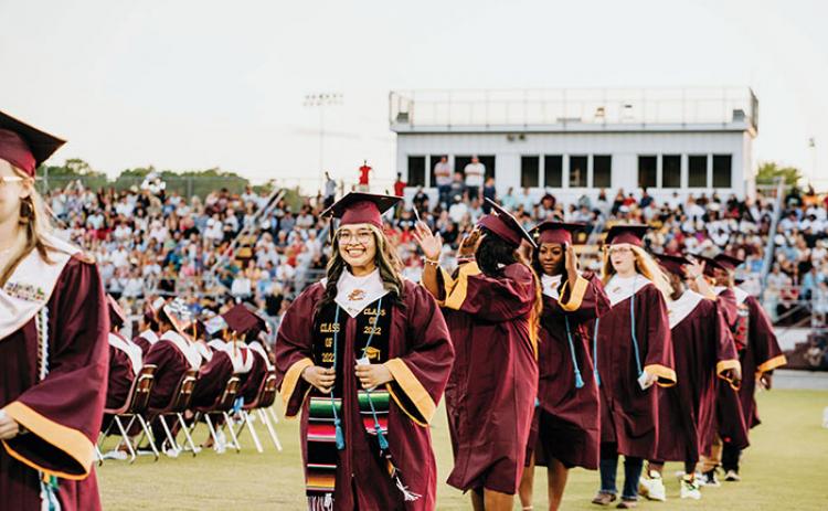 Graduates at Crescent City Junior-Senior High School walk toward the stage to receive their diplomas during Thursday’s commencement ceremony.