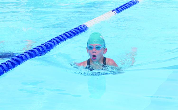 Putnam Sharks swimmer Presley Roberts swims her leg of the winning 8-and-under 100-yard medley relay Saturday at the Putnam Aquatic Center. (MARK BLUMENTHAL / Palatka Daily News)