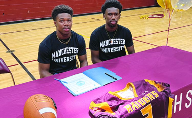 Brothers Naykeem (left) and Naykee Scott pose before signing letters of intent to play at Manchester University in Indiana last month. (Submitted / Sean Delaney)