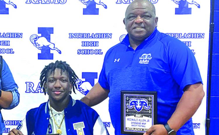 Son Reggie Allen Jr. (left) and father Reggie Allen Sr. show off some of the hardwork the younger Allen won at a recent Interlachen football banquet. (Submitted / Allen family)