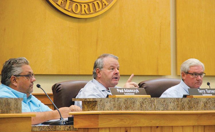 County Commissioner Terry Turner, center, explains why the Board of County Commissioners would not abolish a municipal service benefit unit without all property owners’ input.