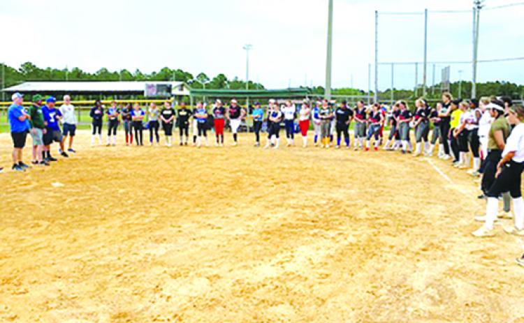 Players listen as several college coaches talk to the girls at the sixth annual North Florida Fastpitch College Prospect Combine Monday at Theobold Sports Complex. (COREY DAVIS / Palatka Daily News)