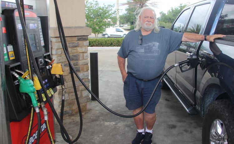 Resident Ken Yelvington pumps gas into his truck at the RaceTrac on State Road 19 Monday afternoon.