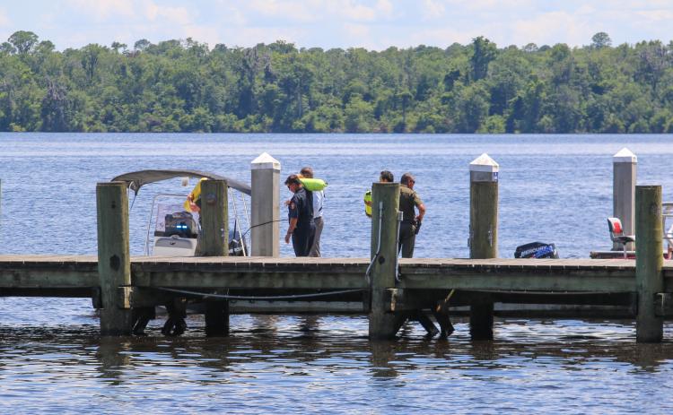 Photo by Sarah Cavacini/Palatka Daily News. Putnam County first responders restock oxygen tanks for a search by boat on the St. Johns River. Officials searched Tuesday for a man who reportedly jumped from the Memorial Bridge earlier that day. 