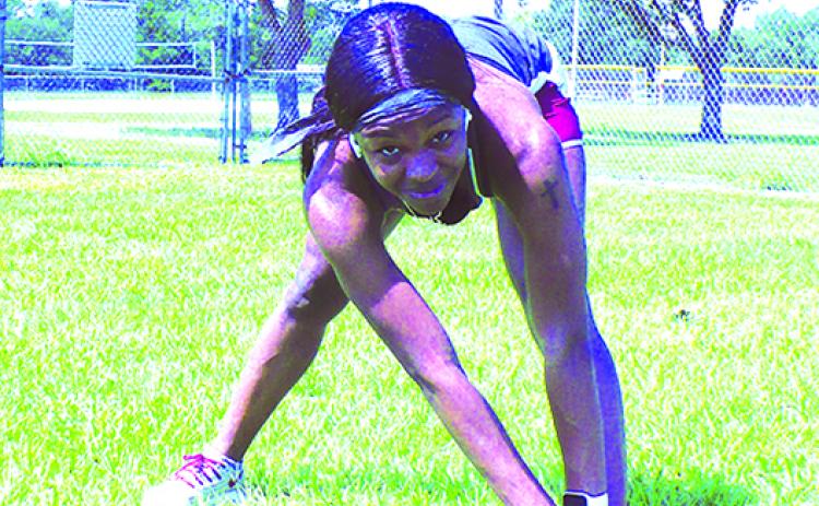 Shown here stretching before a workout in June 2020 at Theobold Sports Complex, former Palatka state champion sprinter Ka’Tia Seymour was a 12-time All-American runner at Florida State. (MARK BLUMENTHAL / Palatka Daily News)