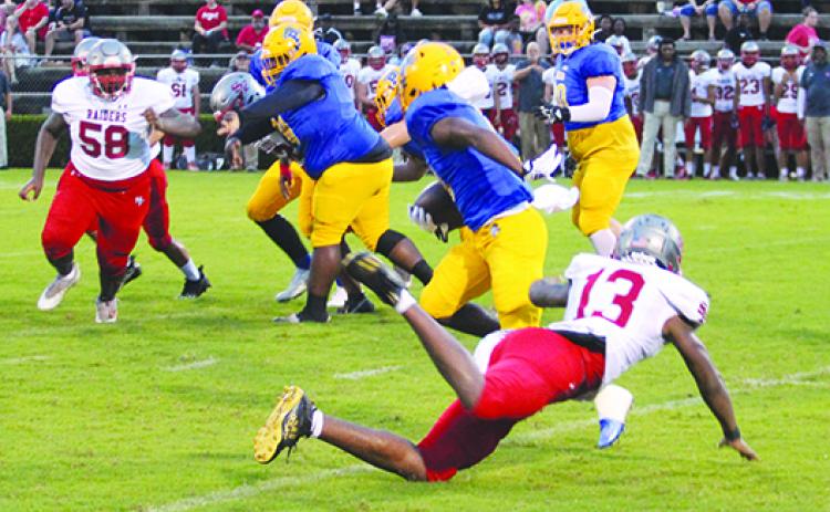 Palatka running back Saiquan Williams (center) makes Alachua Santa Fe defender Duke Lewis miss his tackle attempt during the Panthers’ 33-19 win on Sept. 9 at home. (MARK BLUMENTHAL/ Palatka Daily News)