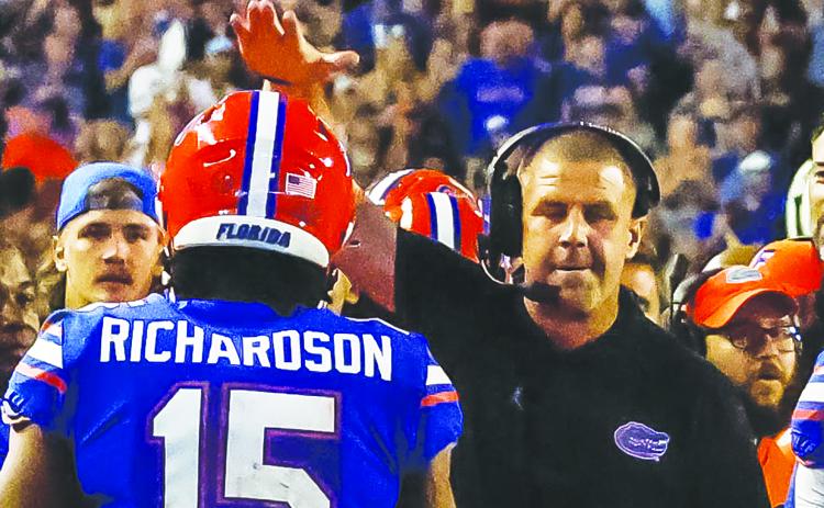 University of Florida quarterback Anthony Richardson gets congratulated by coach Billy Napier after scoring on an 81-yard touchdown run in the fourth quarter Saturday night. (JOHN STUDWELL / Special to the Daily News)