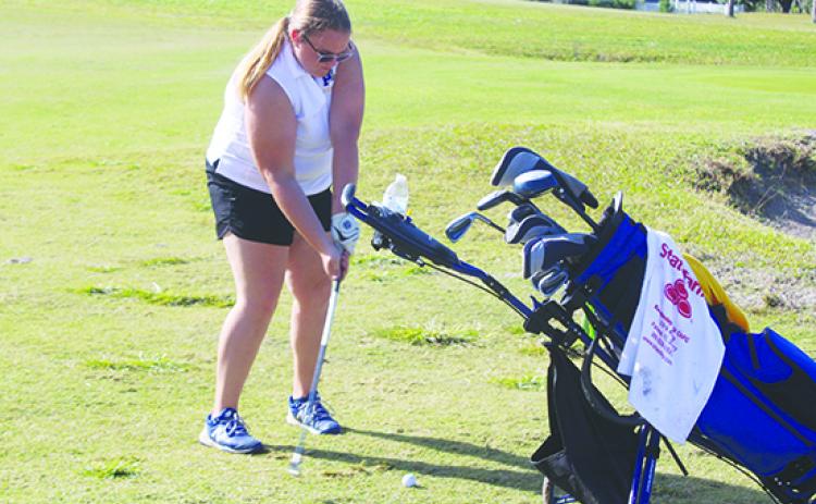 Palatka’s Mara Adams, the team’s lone senior starter, gets set to hit a shot on the 18th hole during Tuesday’s district meet. (MARK BLUMENTHAL / Palatka Daily News)