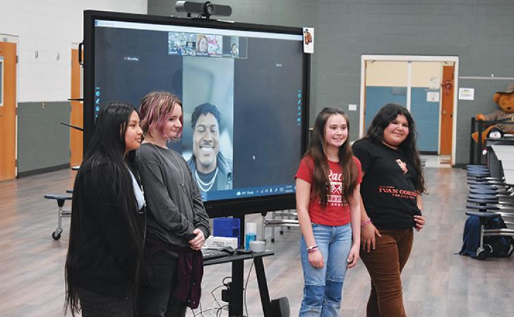 BRANDON D. OLIVER/Palatka Daily News – Browning-Pearce Elementary School students, from left to right, Keily Mendez, Taryn Herndon, Bethanny Robinson and Vianca Vazquez stand on either side of New England Patriot Jonathan Jones during a Zoom call Wednesday.