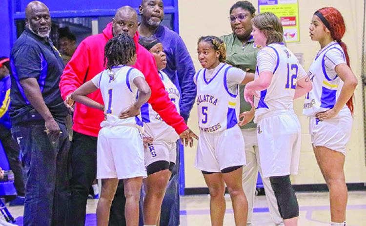 Palatka girls basketball coach Craig Washington (second, left) chats with his team during a timeout last Friday night. (RITA FULLERTON / Special to the Daily News)