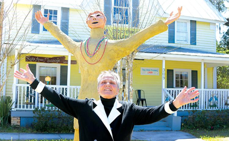 TRISHA MURPHY/Palatka Daily News – Kirsten Engstrom stands in front of the 10-foot-tall statue named “Aariel” with her hands outstretched mimicking the statue she created and donated to the Melrose Center’s Studios of Melrose gallery.