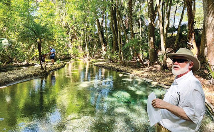 File photo – Sam Carr, president of the Bartram Trail Society of Florida, gives a history lesson in 2023 about Satsuma Spring while a group tours the site.