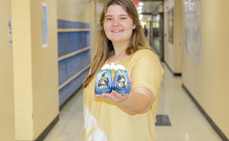 TRISHA MURPHY/Palatka Daily News  Palatka Junior-Senior High School 11th grade student Bella Thomas, 17, shows the “Lungs of the Ocean” sculpture she created that was one of 150 artworks nationwide selected to be exhibited last month in Virginia.