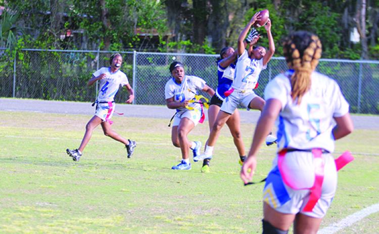 Palatka’s Amaria Mack (2) leaps up to intercept a third-quarter pass in front of Menendez’s Dasani Newsome in Wednesday’s District 8-1A semifinal matchup. Watching the interception for Palatka are Chloe Dasher (left) and Titiana Peeples. (MARK BLUMENTHAL / Palatka Daily News)