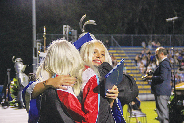 SARAH CAVACINI/Palatka Daily News – A Q.I. Roberts Junior-Senior High School graduate hugs an administrator after receiving her diploma during Saturday’s commencement ceremony.