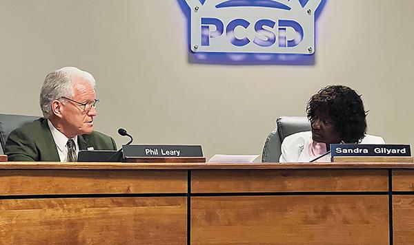CARTER MUDGETT/Palatka Daily News – Putnam County School Board member Phil Leary, left, and Chairwoman Sandra Gilyard, right, discuss the Guaranteed Maximum Price Summary during Tuesday’s board meeting. 