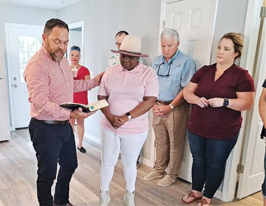 Photo submitted by Ramicah Johnson – Minister Roby Baird blesses Army veteran Sabrina Whittle’s new home at Veterans Village of Palatka in May 2023. Putnam Habitat for Humanity, which oversaw the construction of the home recently received a $25,000 grant from the Frank V. Oliver Jr. Fund.
